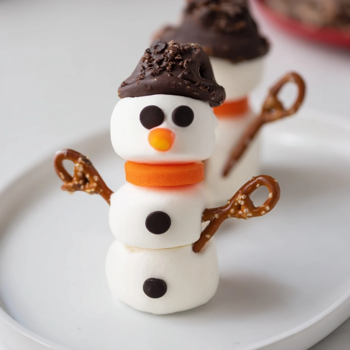 Sweet, no-bake marshmallow snowman sticks: a fun holiday dessert for kids and winter gatherings.