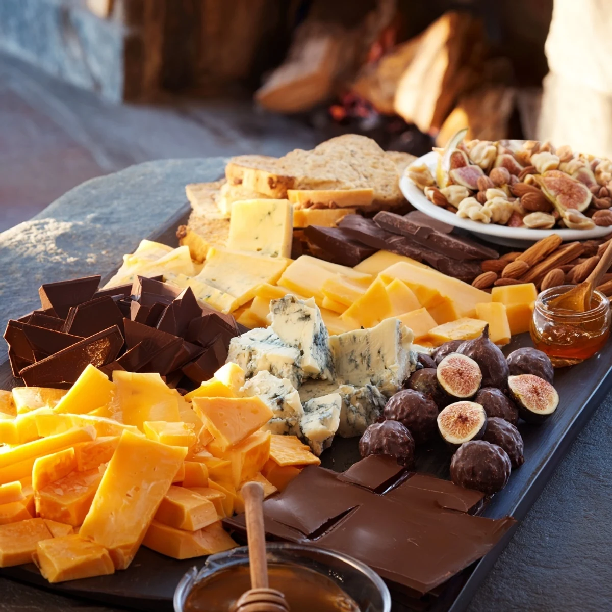 Fireside Comfort & Cocoa: A rustic platter overflowing with cheeses, chocolates, and warm cocoa for a cozy evening.