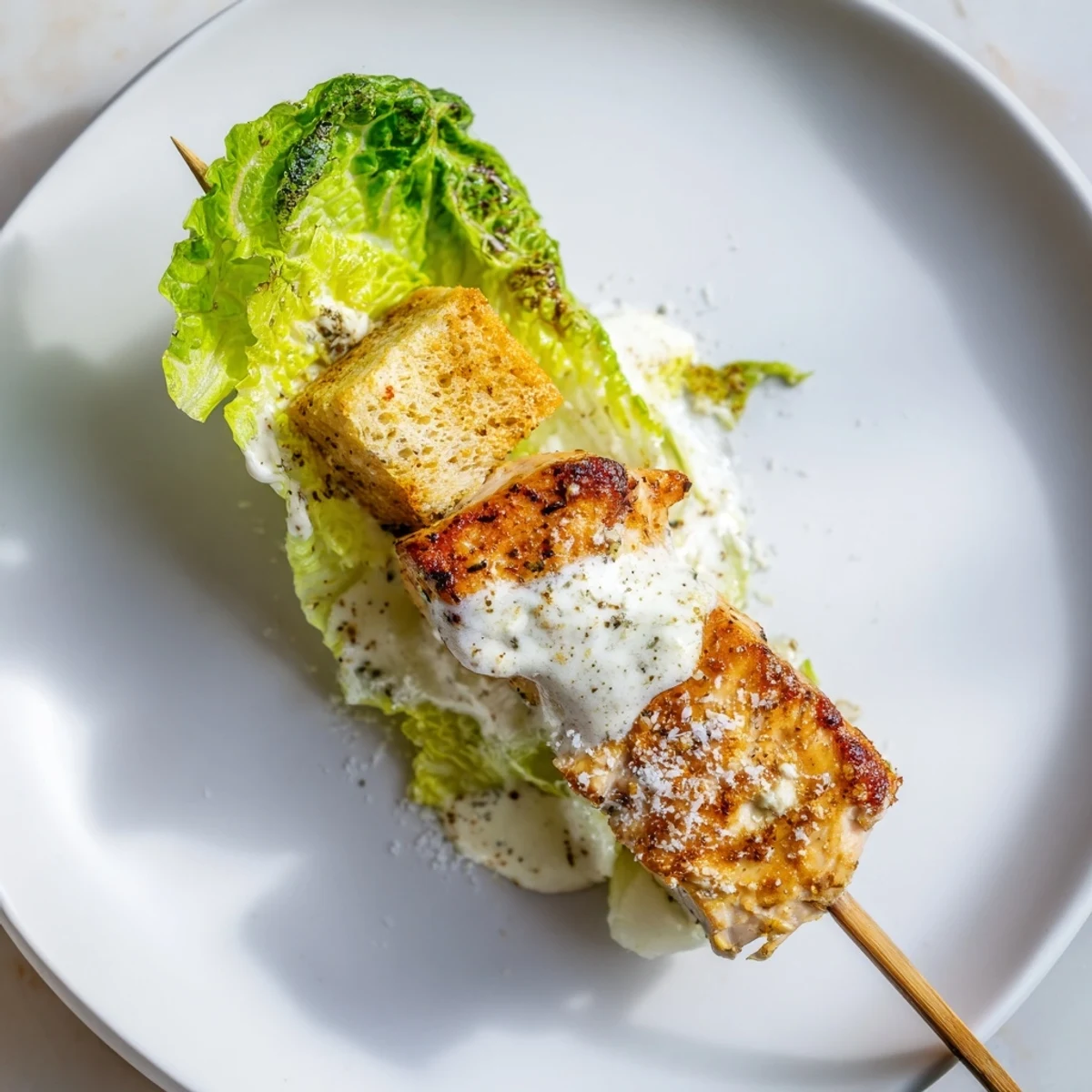 Skewered bites of chicken, lettuce, croutons, and the star, crispy Chicken Caesar Salad Skewers.