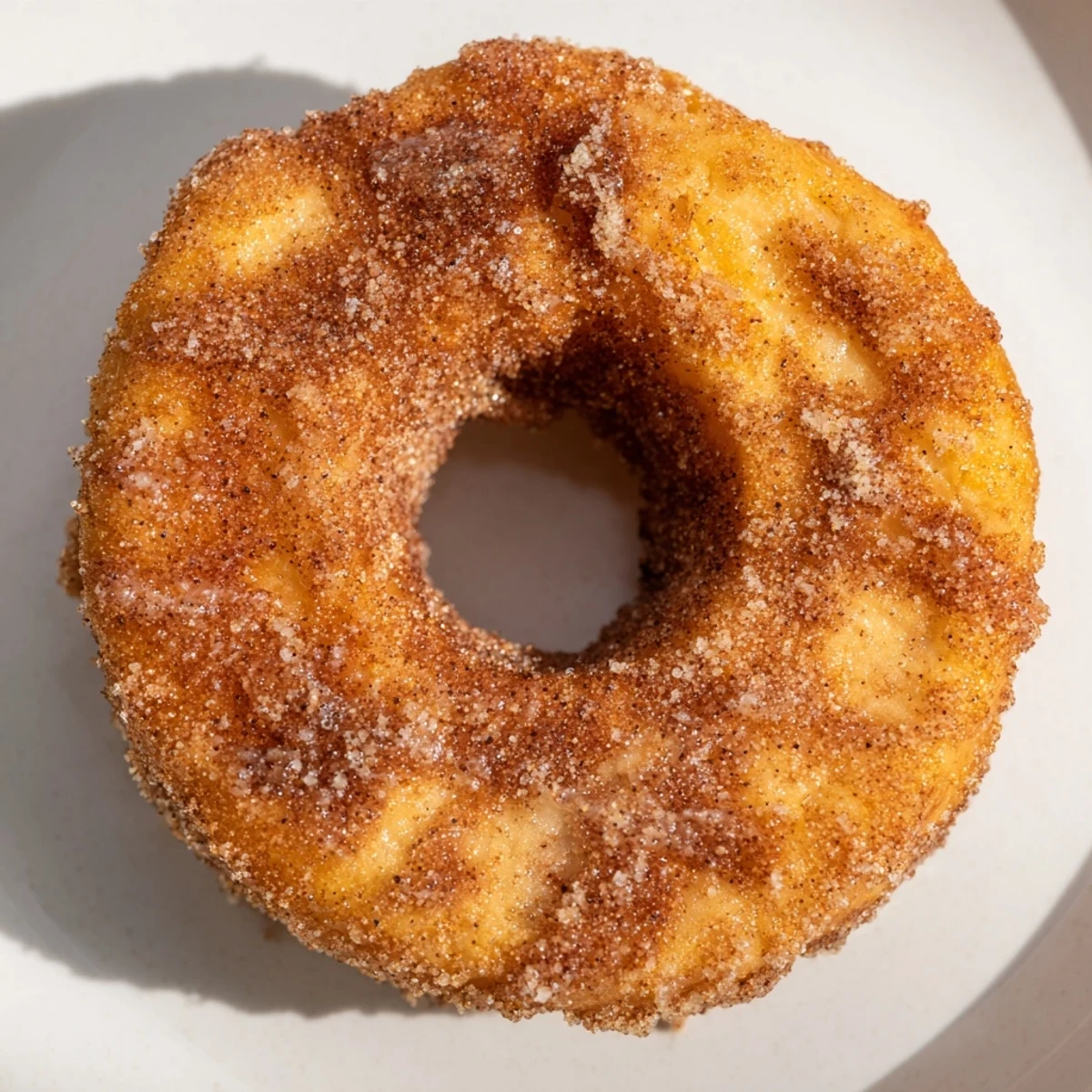 Fluffy 1-Minute Air Fryer Donuts, golden and coated in cinnamon sugar, ready to be enjoyed.