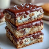 Clotted cream cookie bars with white chocolate chunks, rich and buttery, served on a rustic wooden board.