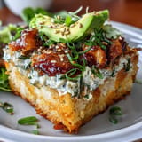 Golden-fried rice bites with a spicy tuna topping, garnished with sesame seeds and green onion for bold flavor.