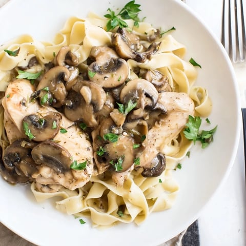 Golden pan-seared chicken breasts in a creamy Marsala mushroom sauce, served over al dente fettuccine with fresh parsley.  