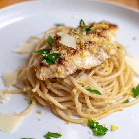 Golden brown butter sauce coats tender spaghetti and seared chicken in this Brown Butter Lemon Chicken Pasta, garnished with fresh parsley and lemon wedges.