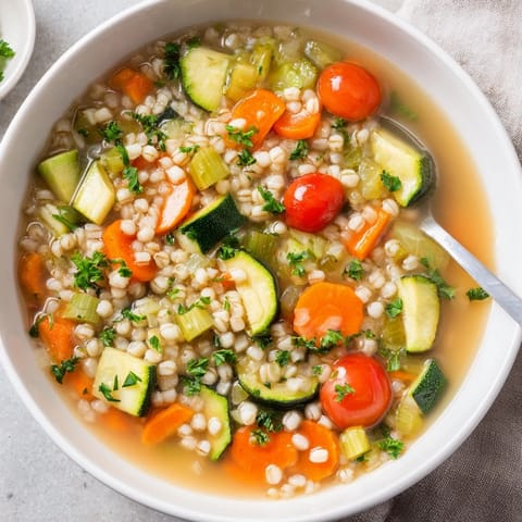 A rustic shot of Simple Homemade Grain and Vegetable Soup, perfect for a cozy vegetarian dinner.