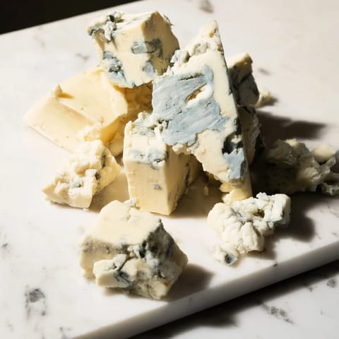 Irregular blue cheese and cheddar chunks create a flavorful Marble Quarry cheese board ready to enjoy.