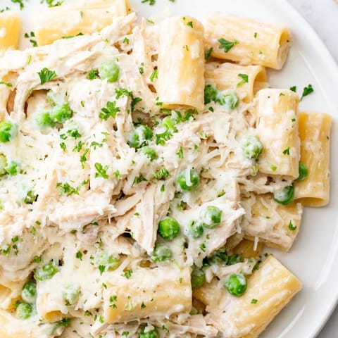 A flavorful Slow Cooker Chicken Alfredo Pasta Bake, tender chicken combined with creamy pasta.