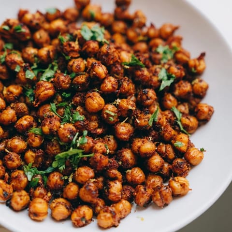 Vibrant image of oven-roasted Harissa Chickpea Roast, seasoned to perfection and ideal for snacking.