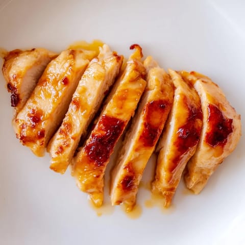 Freshly assembled Honey Mustard Chicken Wrap, filled with tender chicken, crunchy romaine lettuce, and a creamy honey-mustard sauce on a soft tortilla.