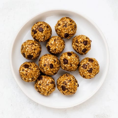 Ripe banana, oats, and almond butter mix into Banana Chocolate Chip Energy Balls, perfect for a healthy snack.