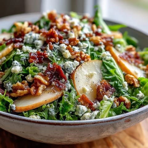 Frisée Pear Blue Cheese Bowl with crisp prosciutto and toasted walnuts tossed in vinaigrette.