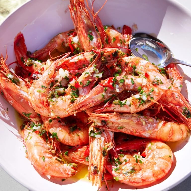 Enjoy a bowl of Lemon Herb Shrimp Scampi, perfectly cooked shrimp with a zesty herb sauce, ready to serve..