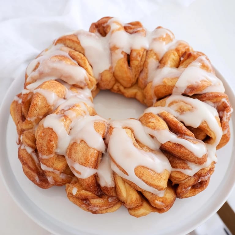 Freshly baked Cinnamon Roll Pull-Apart Wreath, showcasing delicious layers and a delightful aroma with every bite.