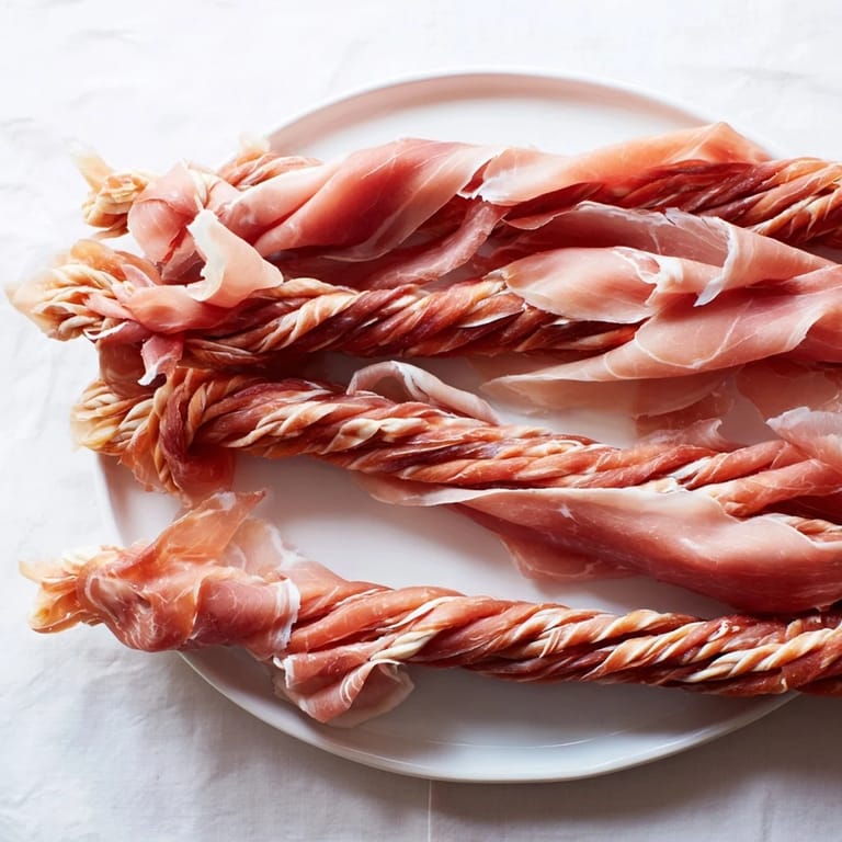 A close-up of a beautifully braided Nautical Knot, showcasing the salty prosciutto and cheesy threads.