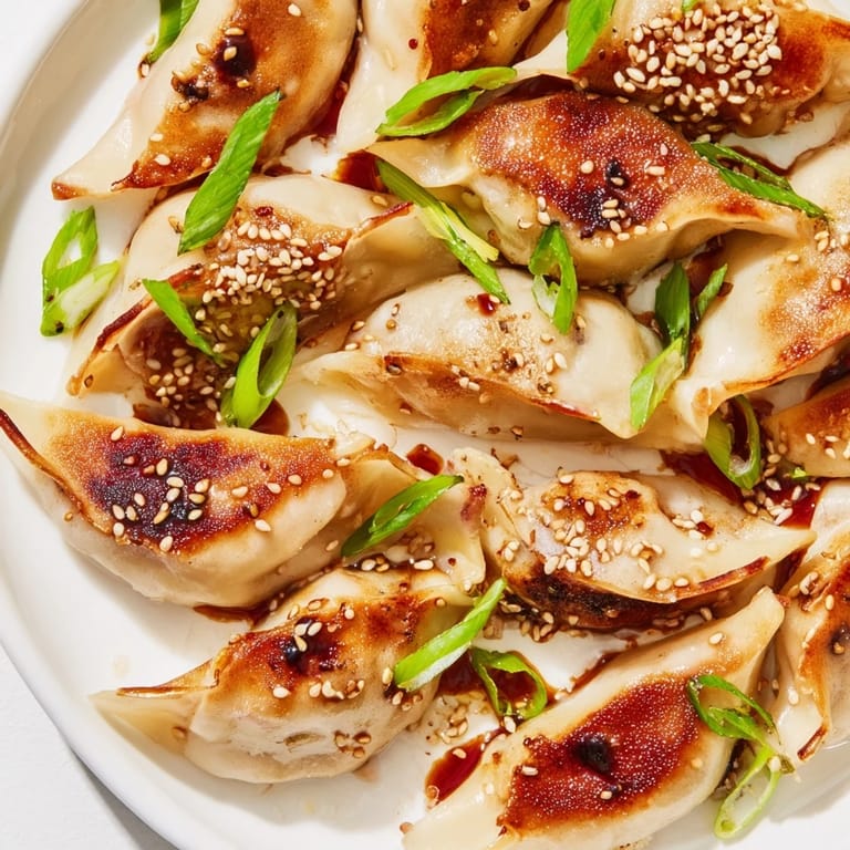 A close-up of air-fried Frozen Dumplings, glistening with a savory glaze for a delicious appetizer.