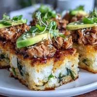 Crispy rice squares topped with spicy tuna and creamy avocado, perfect for a sushi-inspired appetizer.